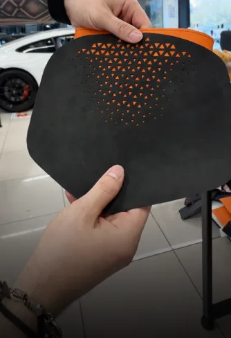 Custom perforated panel with orange backing made at DEIZ