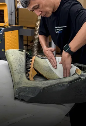 DEIZ craftsman reshaping seat foam on the frame
